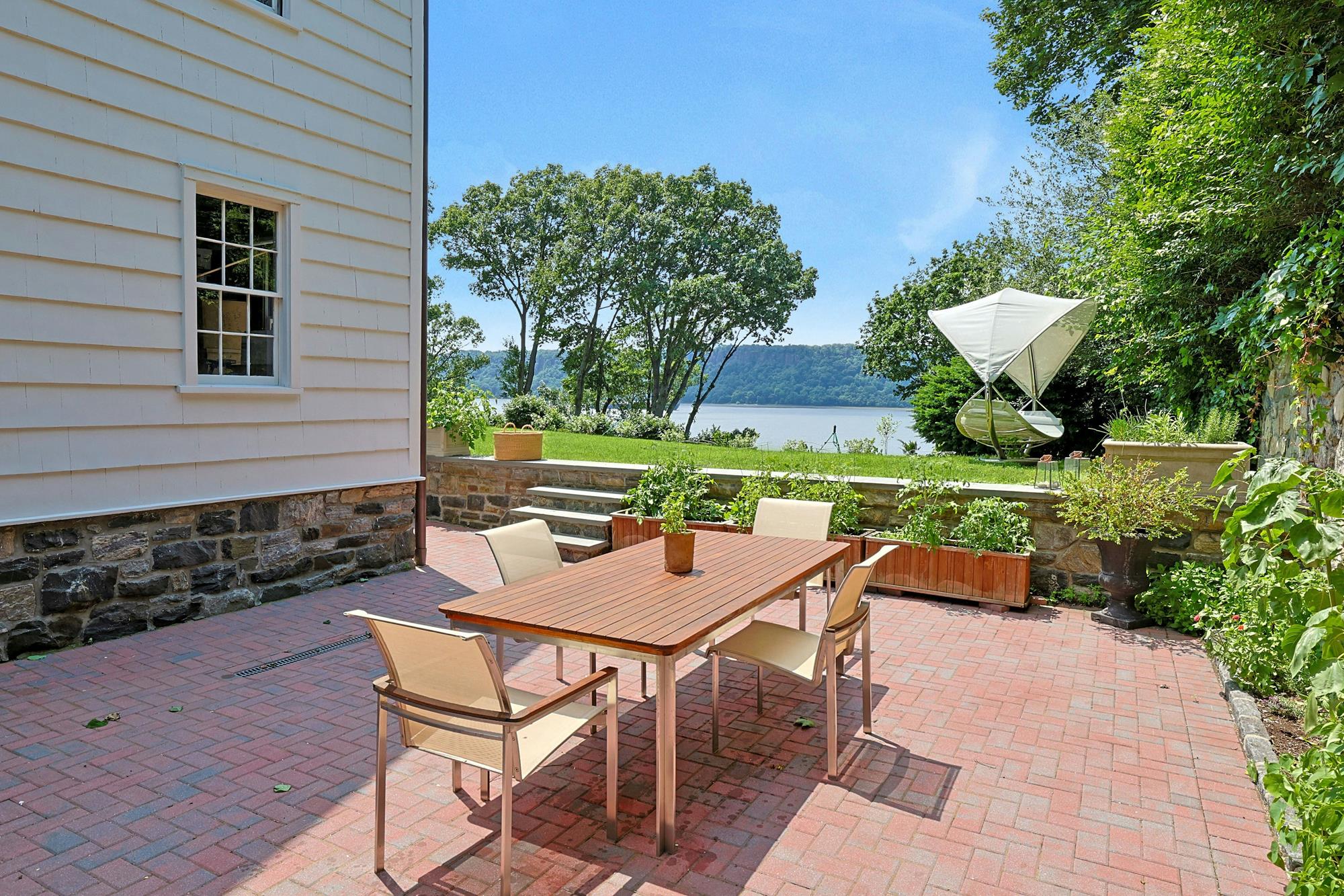 A walled sunken patio for al fresco dining, the river just beyond.